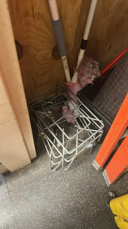 Janitorial supply package lot. Includes yellow poly mop bucket with wringer on casters, multi-tier chrome wire shelving unit, squeegee, mop handles, w