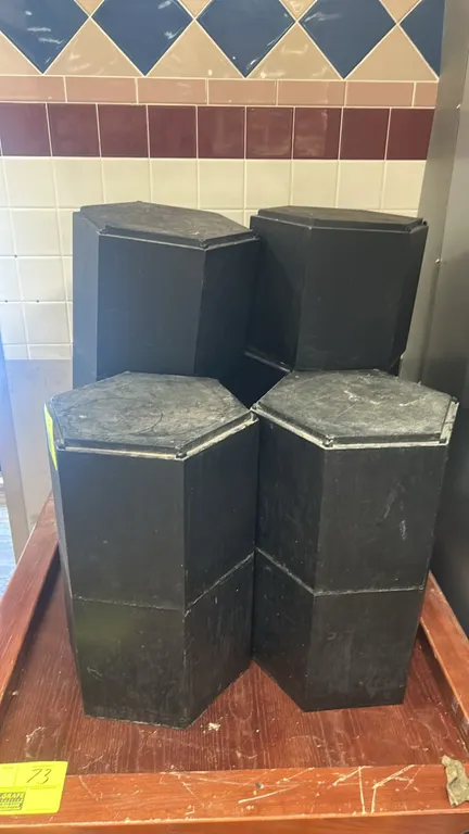 Black hexagonal display risers. Features modular stackable construction with a black finish. Dimensions: 1'H.