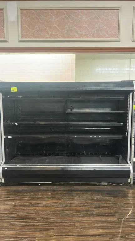 1999 Hussmann D5-8LE U multi-tier medium-temp open display case. Features adjustable solid metal shelving, canopy lighting, and black exterior trim. 8
