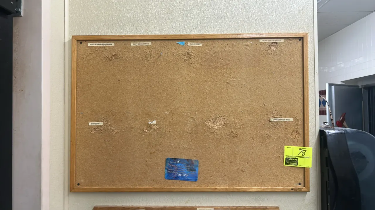 Quartet cork bulletin board. Features an oak-finish wood frame. 3'W x 2'H.