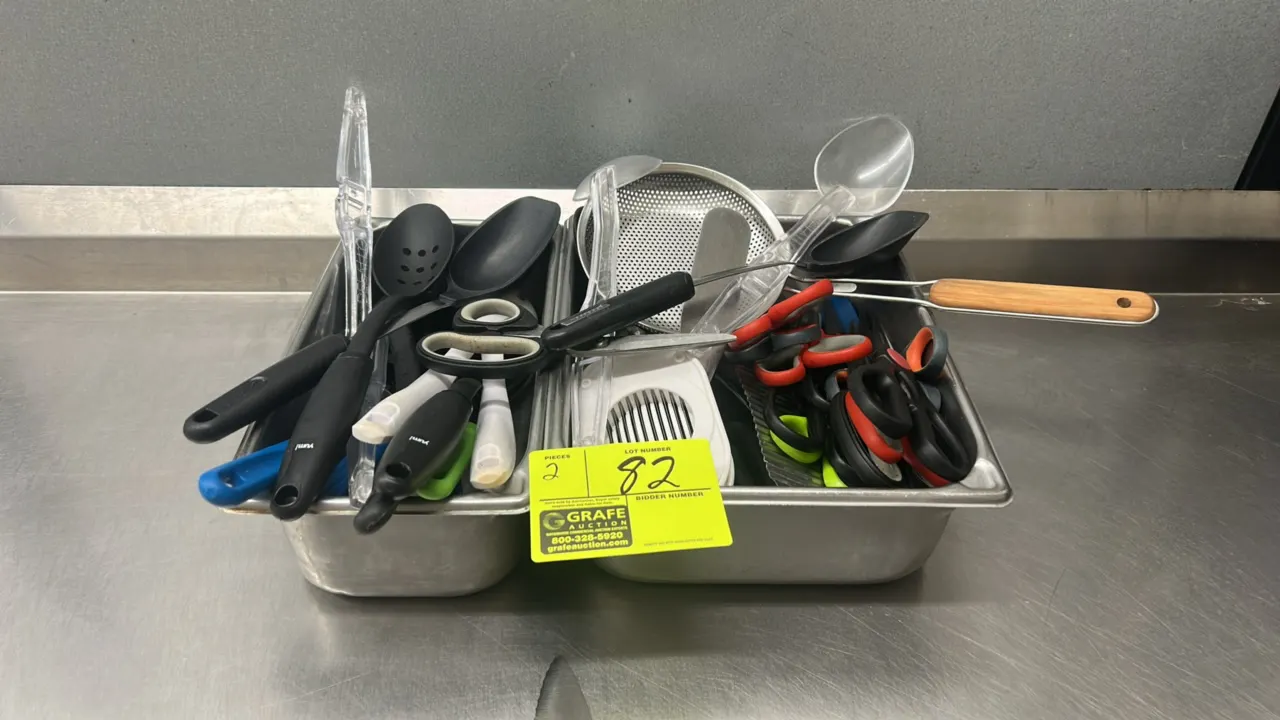 Stainless steel insert pans with kitchen utensils. Includes poly spoons, kitchen scissors, tongs, icing spreaders, egg slicer, wire skimmer, crinkle c