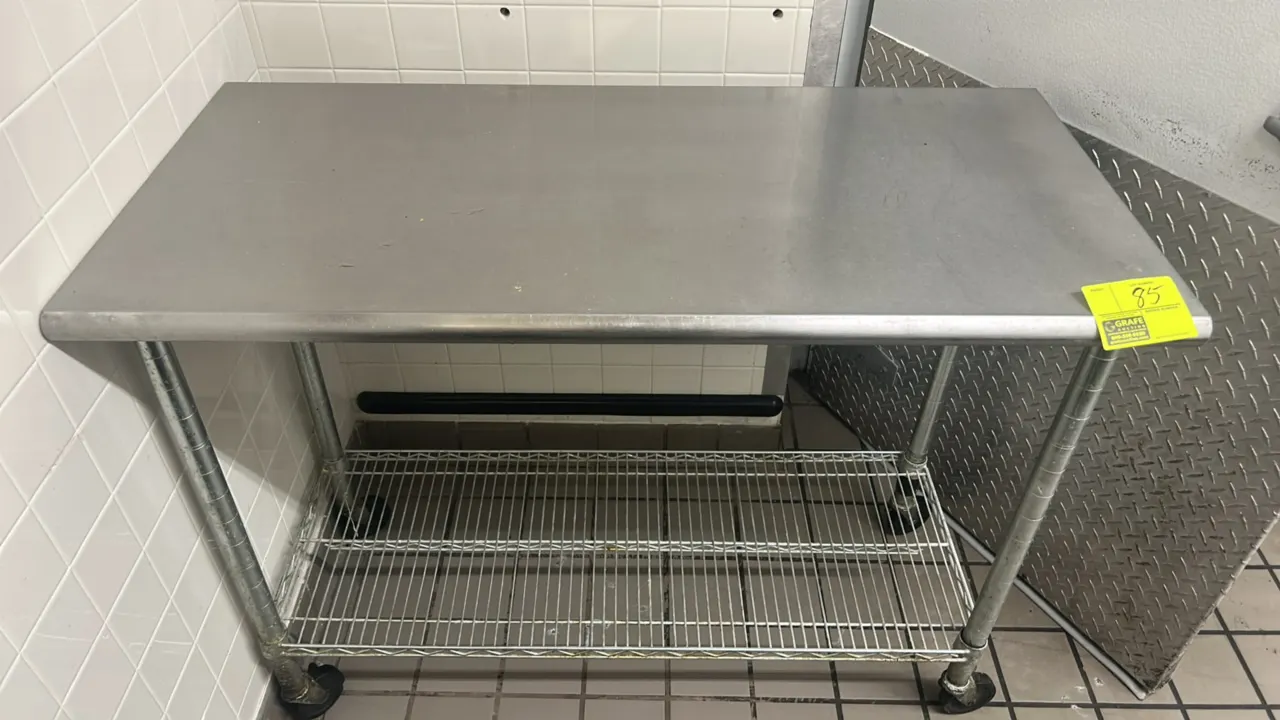 Stainless steel portable work table. Features a stainless top with rolled front and rear edges and an adjustable lower wire undershelf. 4'L x 2'W. Mou