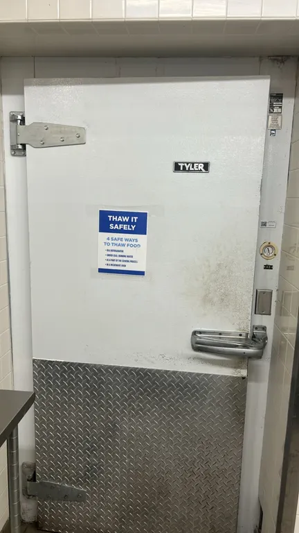 Tyler foam panel walk-in freezer. Features insulated foam panels, hinged entry door with diamond plate kick plate, Tyler 2-fan evaporator coil, and in