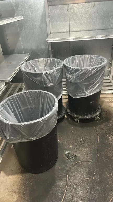 Poly bulk trash bins. Features durable black polyethylene construction and round open-top design. Includes (2) mobile caster dollies.