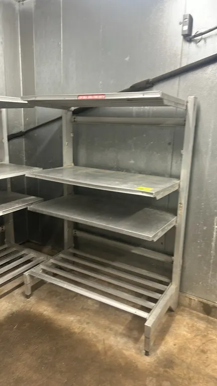 Aluminum cantilever storage racks. Features 4-tier design with slatted bottom dunnage base, solid intermediate cantilever shelves, and top shelf. 4'L.