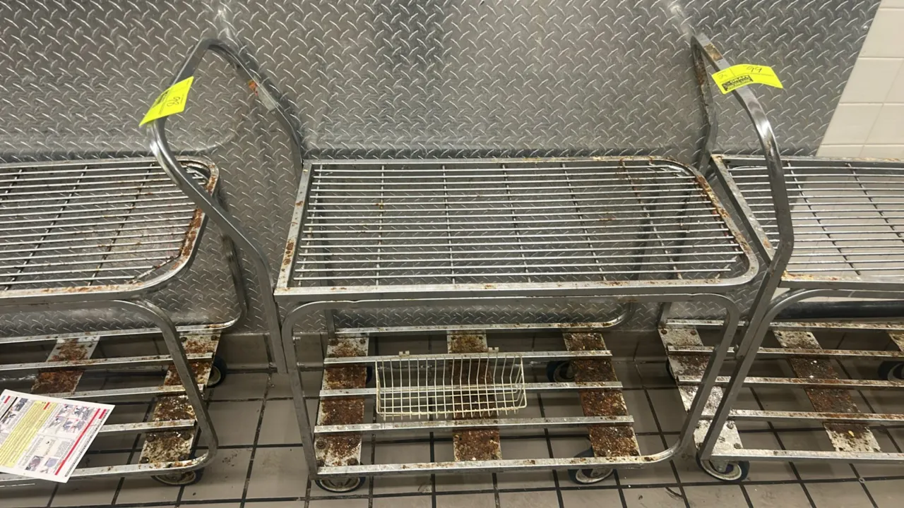 Metal 2-tier stock cart. Features wire upper shelf, lower base shelf, integrated tubular push handle, and hanging wire basket. 3'L. Mounted on casters