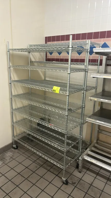 Multi-tier mobile wire shelving racks. Features adjustable wire shelves. 48"W x 18"D. Mounted on casters.