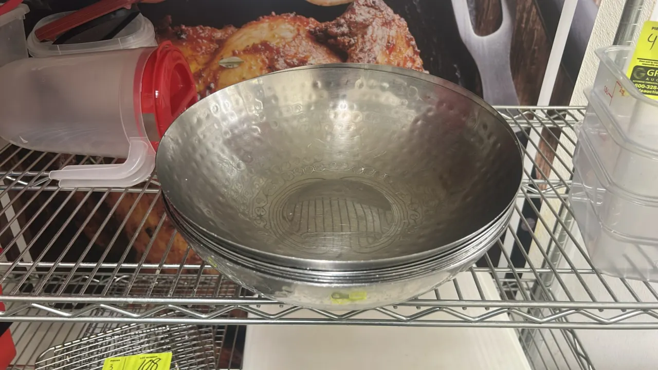 Hammered metal serving bowls. Features a hammered textured finish and stackable round design. 1' diameter.