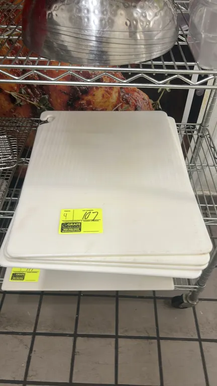 Poly cutting boards. White polyethylene construction with molded hanging hooks. 24" x 18". Wire cart and background items not included.