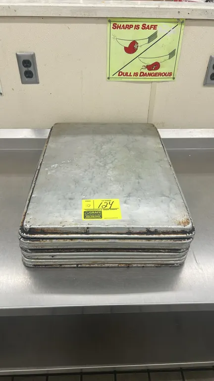 Full-size metal sheet pans. Lot of (10) commercial baking sheet pans featuring wire-reinforced rolled rims.