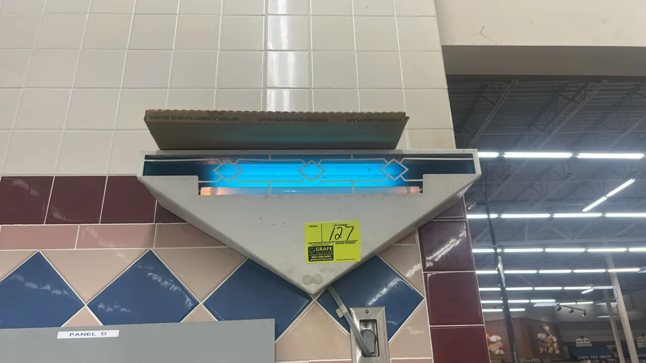 Gardner wall-mounted insect light trap. Features decorative metal wall sconce design, ultraviolet insect attraction light, and glue board trapping sys