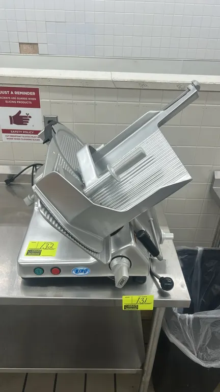 2022 Biro B 350 M metal deli meat slicer. Features manual gravity feed carriage, product pusher, slice thickness adjustment knob, and push-button cont