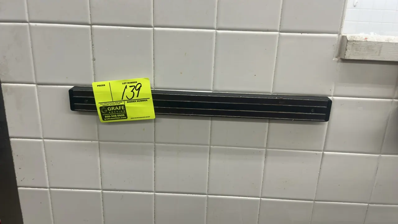 Wall-mount magnetic knife bar. Features dual magnetic strips and black frame. Wall mounted.