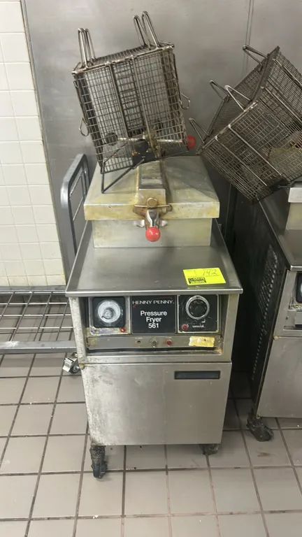 Henny Penny 561 commercial pressure fryer. Features stainless steel construction, mechanical timer and temperature controls, locking lid mechanism, in
