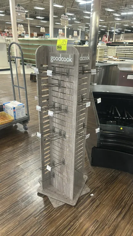 GoodCook 4-sided rotating slatwall merchandiser display. Features a gray woodgrain laminate finish, slatwall panels on all four sides, GoodCook brande