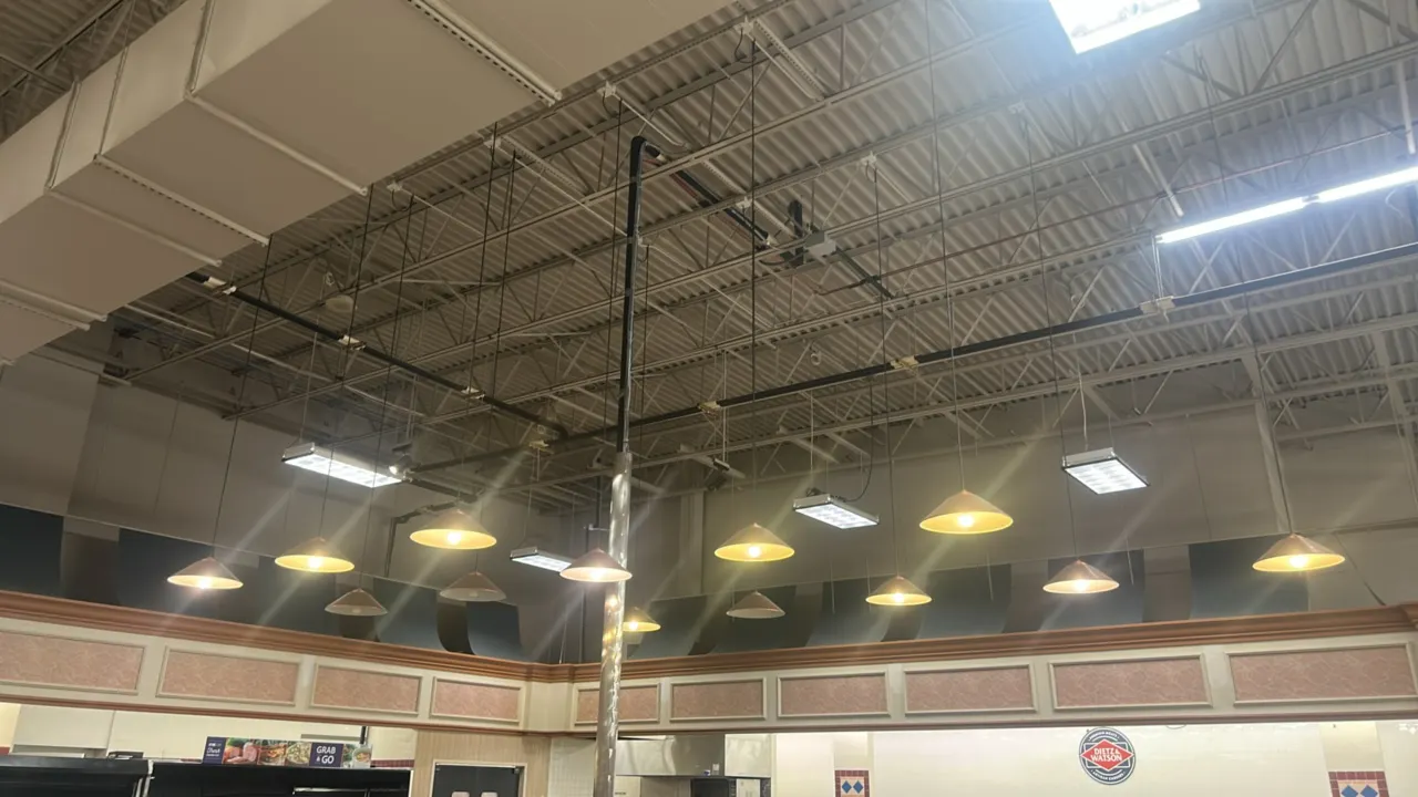 Metal ceiling-hanging pendant lights. Features shallow cone-style metal shades with single bulb sockets and suspension cords. Designed for overhead ce