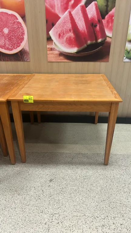Wooden nesting display table. Features light oak wood finish and four tapered square legs. Dimensions: 4' x 4'.