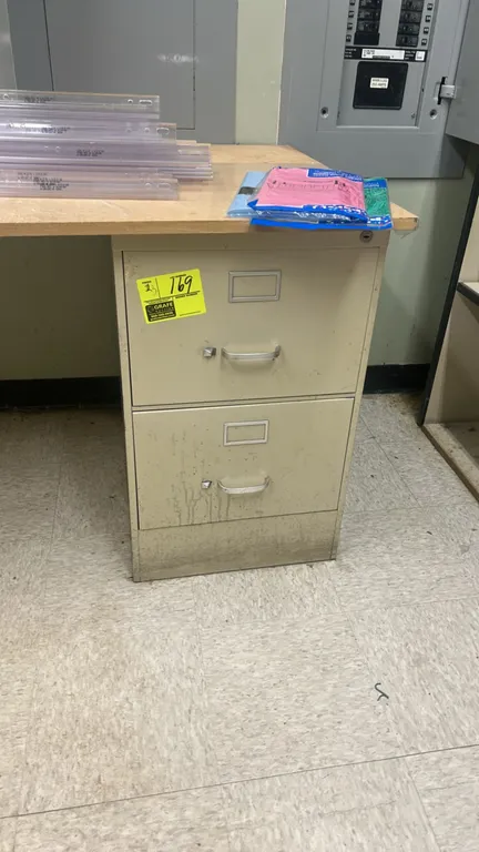 Metal 2-drawer filing cabinets. Features metal construction with pull handles and integrated label holders. Note: Desk tops and contents not included.