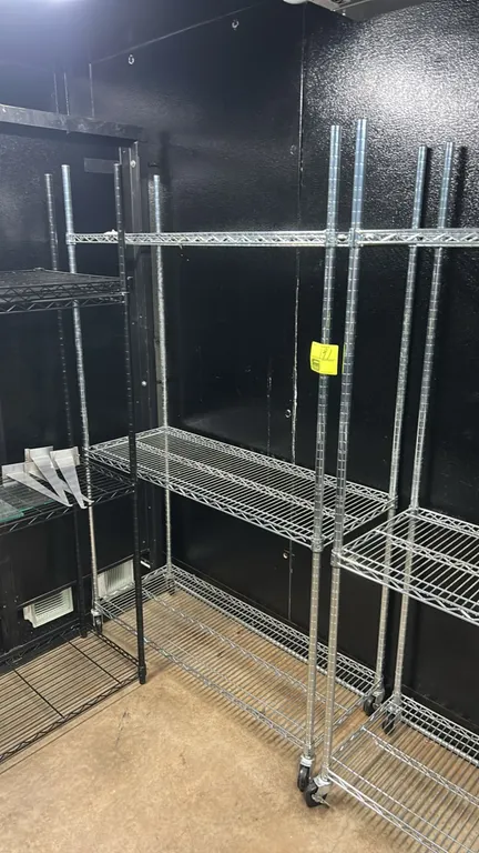 Stainless steel 3-tier portable wire shelving rack. Features adjustable wire shelves. 48" x 18". Mounted on casters.