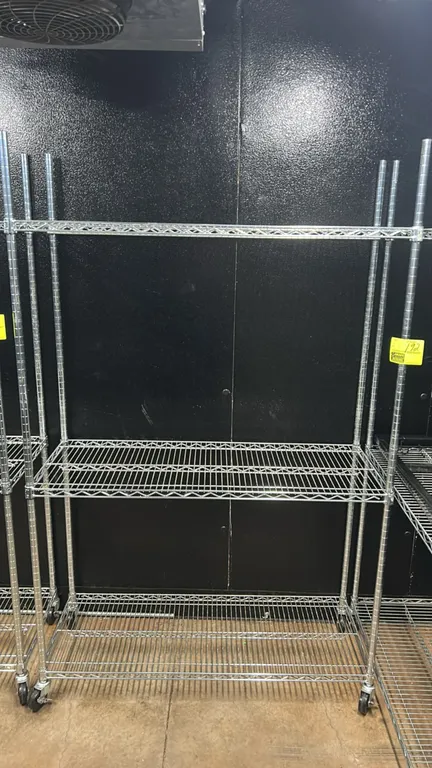 Stainless steel 3-tier portable wire shelving racks. Features 3 adjustable wire shelves. 48" x 18". Mounted on swivel casters.