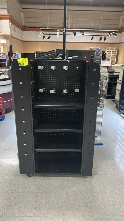 Metal portable 3-sided candy and magazine display rack. Features black metal construction, pegboard backing, adjustable shelves, wire magazine racks,