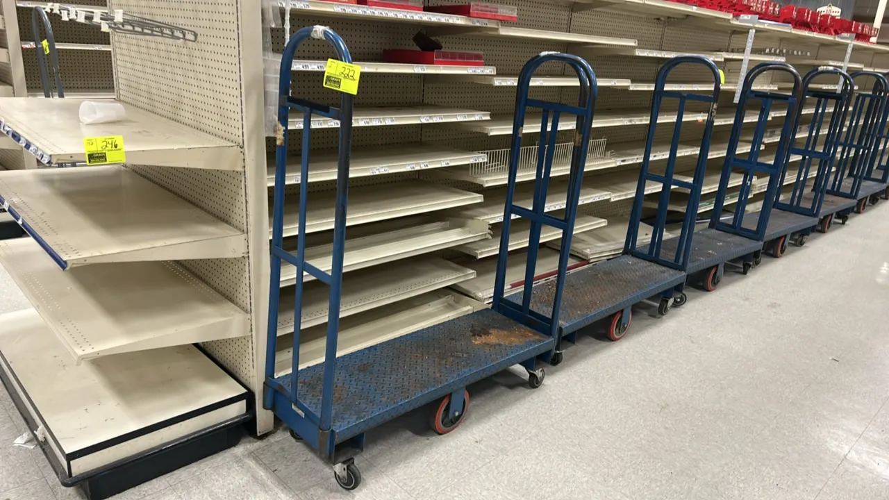 Metal U-boat stocking carts. Features blue painted steel construction, diamond plate platform decks, and dual tall tubular end handles. 4'L. Mounted o