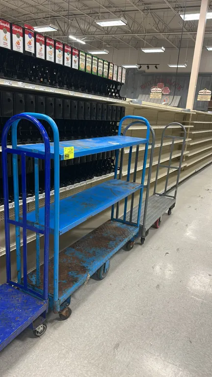 Metal U-boat stocking carts. Includes blue multi-shelf cart and gray diamond-plate platform cart. 5'L. Mounted on casters.