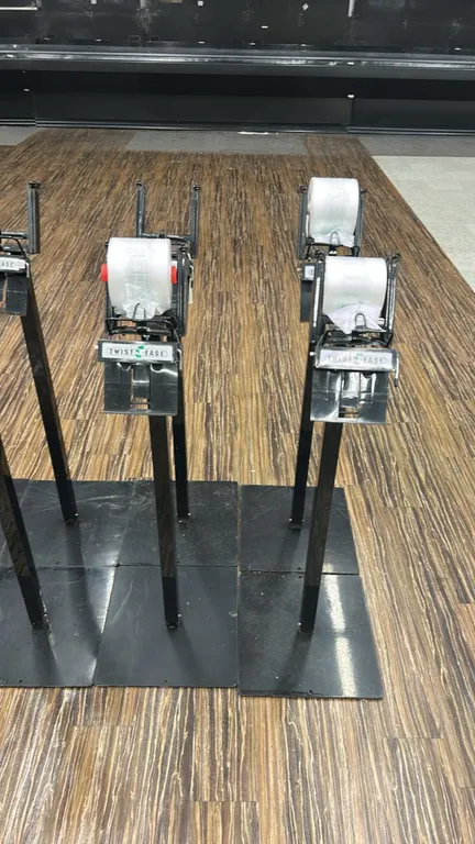 Twist-Ease metal produce bag dispenser stands. Features roll bag cradles, integrated Twist-Ease tie dispensers, and black metal post construction moun