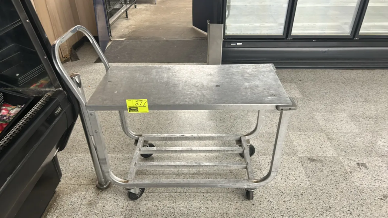Aluminum utility stock cart. Features a solid top shelf, slatted lower shelf, integrated push handle, and protective corner bumpers. 44"L. Mounted on