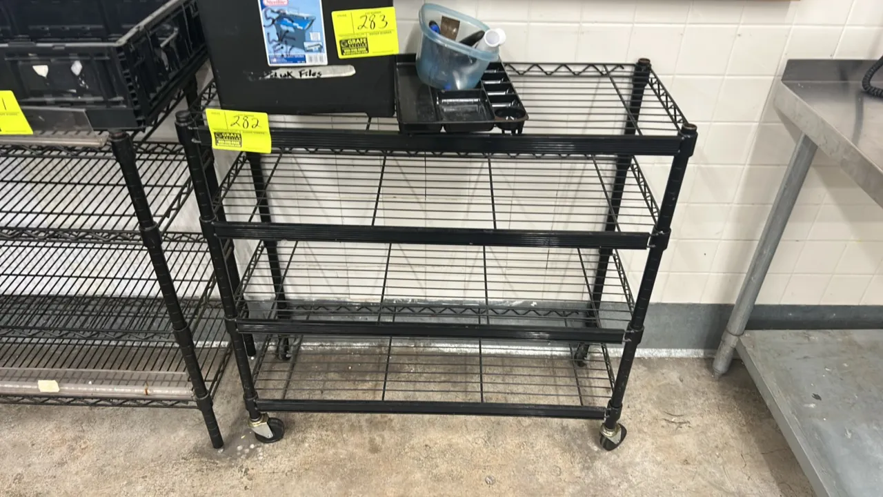 Metal wire multi-tier portable rack. Features 3 wire shelves with black finish and shelf label channels. 36" x 14". Mounted on swivel casters. Content