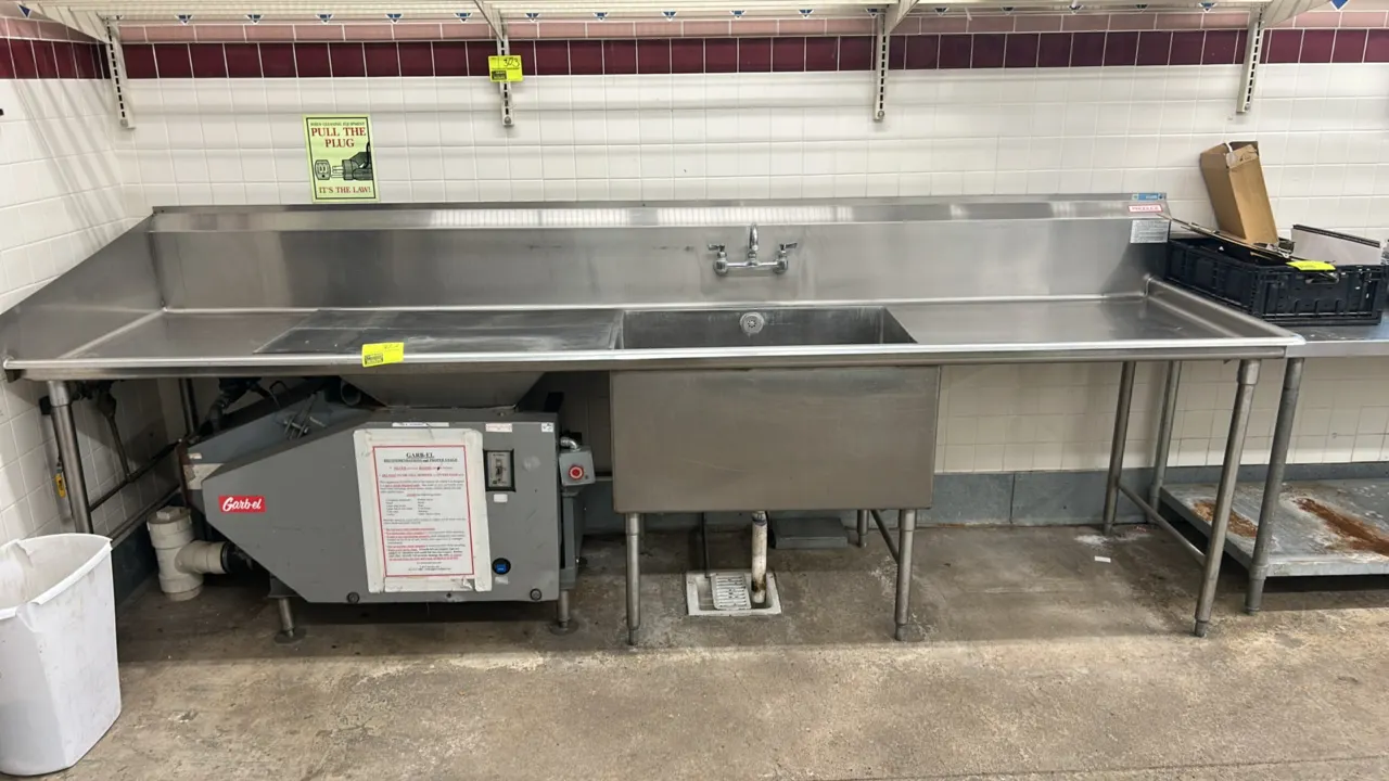 Stainless steel 1-compartment sink with integrated Garb-el commercial food waste disposer. Features left and right drainboards, high backsplash, and s