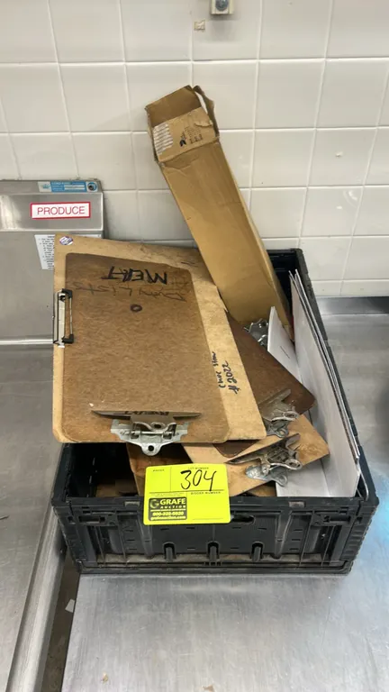 Quantity of hardboard clipboards with metal clips. Includes black collapsible poly storage crate.