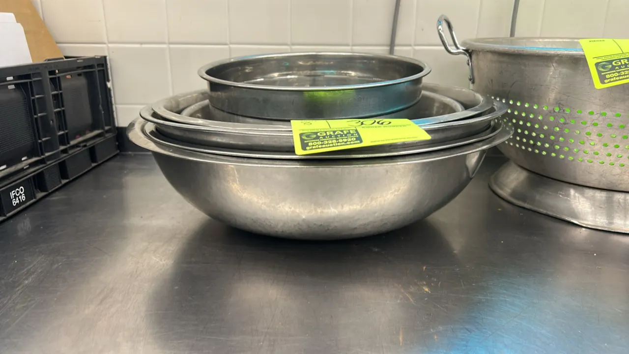 Assorted stainless steel mixing bowls. Features durable stainless steel construction and nesting design in varied sizes.