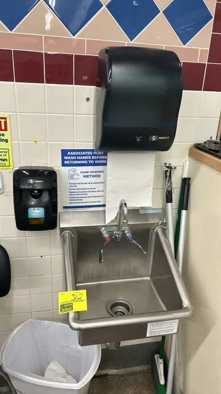 Stainless steel handwashing sink. Features gooseneck faucet with wrist-blade handles, integrated splash guards, and drain. Includes Triple S paper tow
