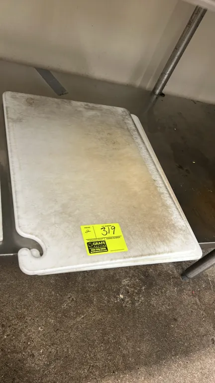 Polyethylene cutting boards. Features white poly construction with corner hanging hook handle design, perimeter groove, and embossed edge ruler markin