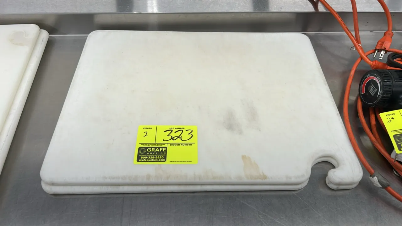 Polyethylene cutting boards. Features white poly construction and integrated hanging hook handle cutouts. Dimensions: 20" x 15".