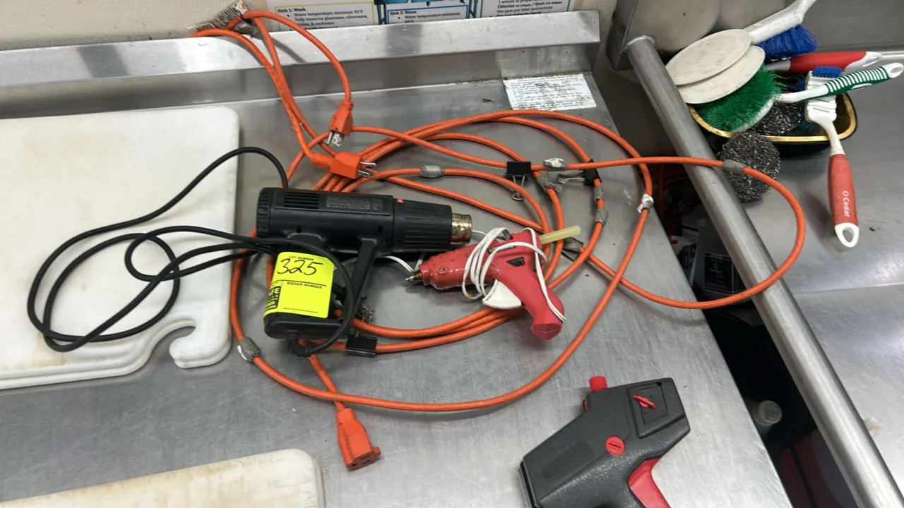 Electric heat gun and glue gun lot. Includes a Hotshot electric heat gun, a Surebonder dual-temperature hot glue gun, and an orange extension cord. He