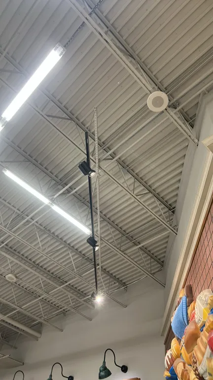 Black track lighting fixtures. Features adjustable spotlight heads with a black finish. Designed for commercial track lighting systems.