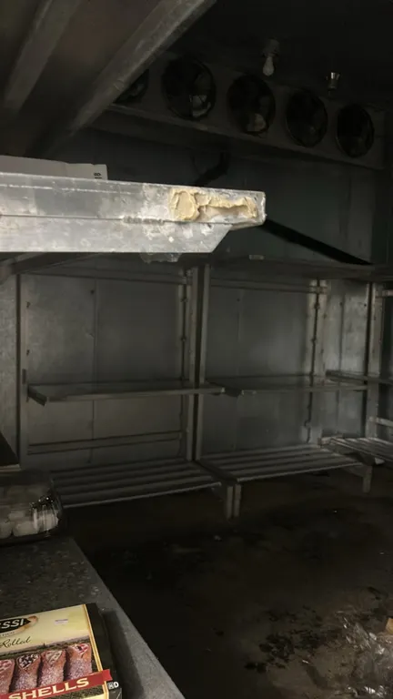 Metal walk-in shelving racks. Features multi-tier adjustable shelving with slatted lower deck and solid upper tiers. 4'L each. Cooler structure and co