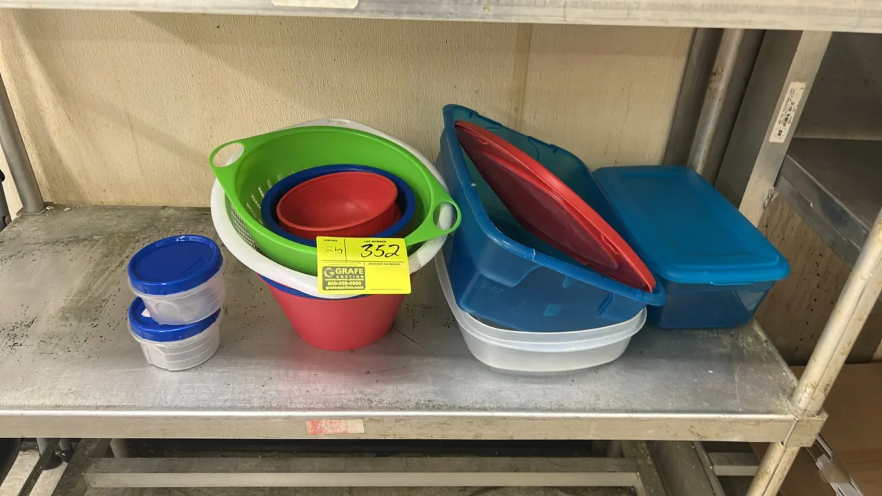 Assorted plastic kitchenware lot. Includes poly colanders and strainers, nesting mixing bowls, and storage containers with lids in various sizes and c