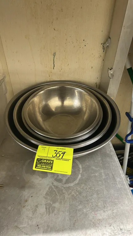 Stainless steel mixing bowls. Features assorted sizes, rolled rims, and nesting design.