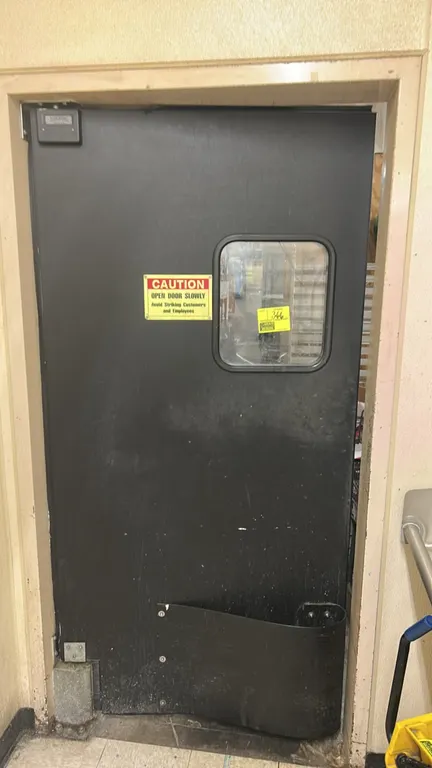 Poly swing impact door. Features a clear vision panel window, bumper guard, and pivot hinge mounting hardware. 42"W x 84"H.