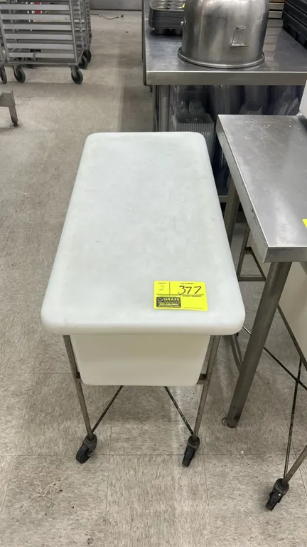 Poly ingredient bins with metal carts. Features white polyethylene bin construction with fitted lids. 32"L. Mounted on metal wireframe carts with cast