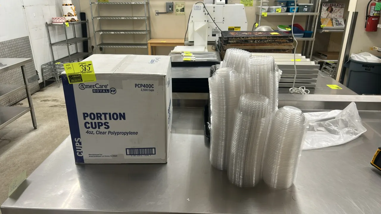 Quantity of assorted packaging goods. Includes AmerCare Royal 4 oz clear polypropylene portion cups (model PCP400C), AmerCare Royal portion cup lids (