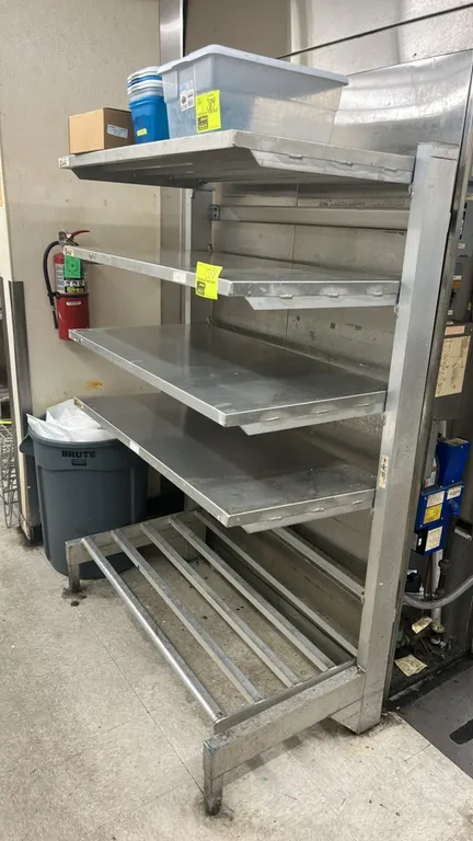 Metal multi-tier shelving rack. Features heavy-duty metal construction with 4 solid cantilevered shelves and 1 bottom tubular slatted shelf. 46" x 26"