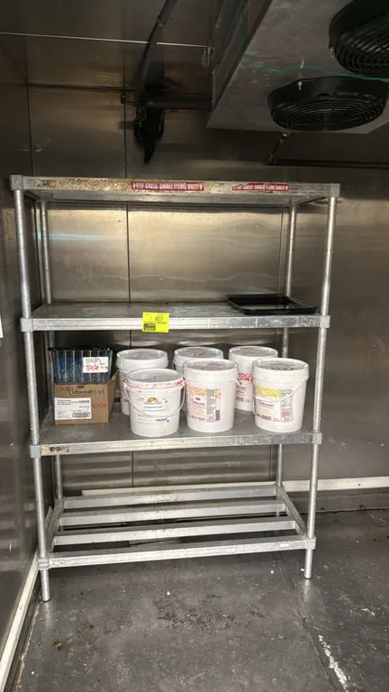 Aluminum 4-tier shelving rack. Features three solid upper shelves and one lower tubular dunnage shelf. Dimensions: 48"W x 20"D x 68"H. Contents not in