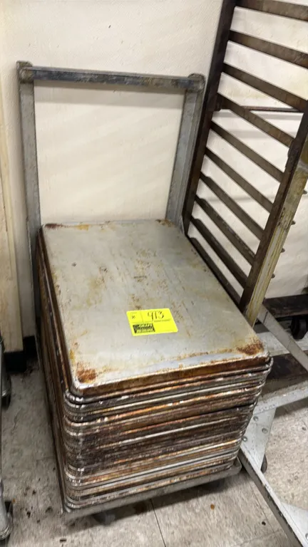 Aluminum 18" x 26" sheet pans. Includes mobile sheet pan dolly with handle and casters. Surrounding racks and tables not included.