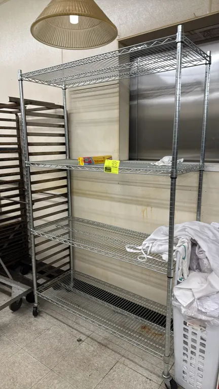 Metro-style 4-tier wire shelving rack. Features chrome wire construction with (4) adjustable shelves. 48"W x 18"D x 76"H. Mounted on swivel casters. C