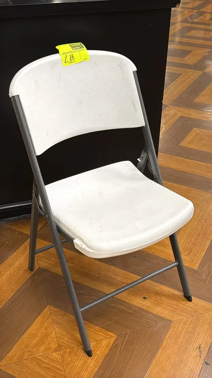 Lifetime folding chair. Features a white molded polyethylene seat and backrest with a gray metal folding frame.