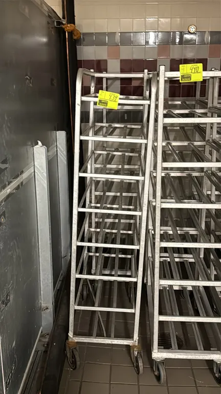 Aluminum meat platter racks. Features welded aluminum construction with multi-tier platter angle runners. Mounted on swivel casters.